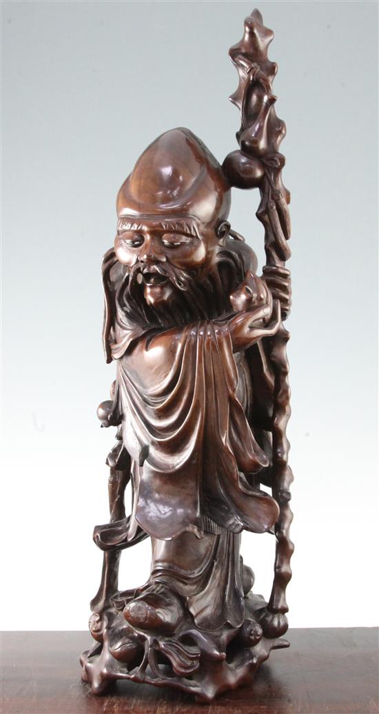 A large Chinese carved wood figure of Shou Lao, 20th century, 57cm